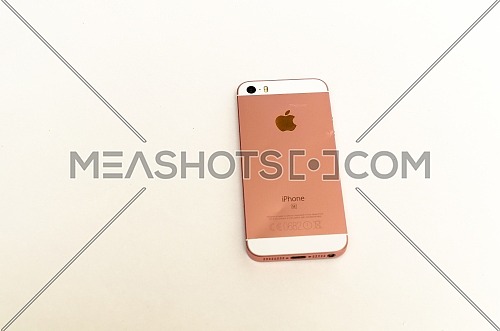 The back of a bent Iphone 5 SE, in white and rose gold. December 2018. Cairo - Egypt