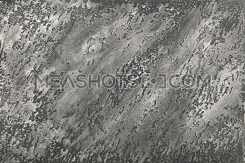Grunge grey faded uneven old aged daub plaster wall texture background with stains and paint strokes, close up