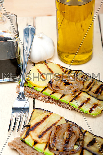 grilled vegetables on rustic  bread over wood table
