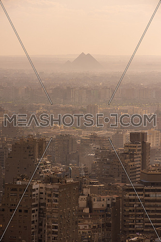 aerial view of modern Cairo city downtown with Nile and pyramids in the distance at beautiful sunny day with blue sky and clouds capital of Egypt