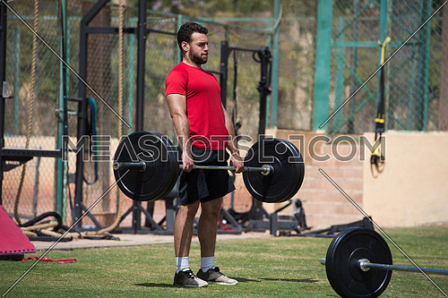 young middle eastern man athlete exercise weightlifting Napoljun on a sunny day