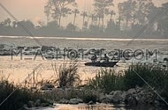 Two Fisher men in a boat during the sunrise at the Early morning in AlQanatir - Egypt