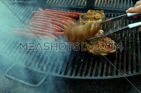 Meat grilling over the hot coals on barbeque