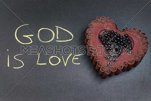 In the picture a rosary iron placed over a heart of red wax, on the left side the inscription \