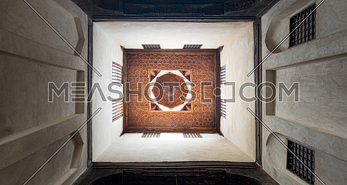 Wooden ceiling of a rooms of El Sehemy house, an old historic Ottoman era house in Cairo, built in 1648, with interleaved wooden windows (Mashrabiya)