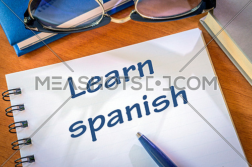 Learn spanish written in a notepad. Education concept