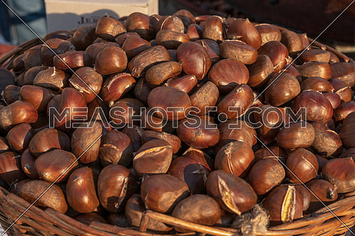 Fresh chestnuts in the basket,sold at the market,sunny day.