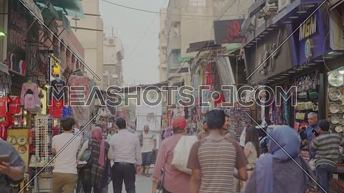 Fixed shot for people walking in El Moez Street in Cairo at day