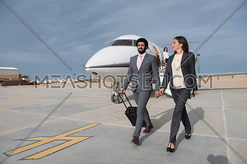 young successful middle eastern businessmen with a suitcase walking in front of private airplane