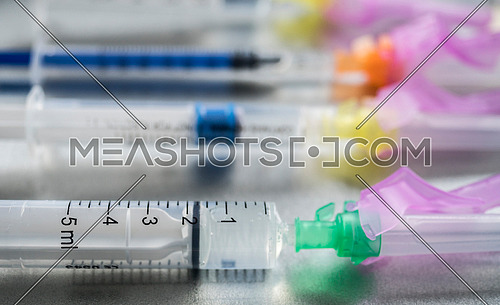 Syringes loaded with medication next to medicine vials prepared in hospital, conceptual image, horizontal composition