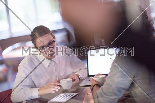 startup business people using laptop preparing for next meeting while drinking coffee and discussing ideas in creative office