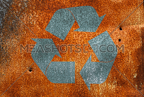 Old vintage bright rust stained corroded metal surface  with grunge recycling logo icon