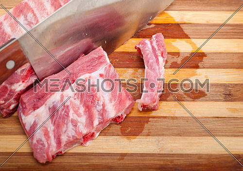 chopping fresh pork ribs ready to cook