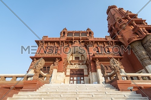 Low angle view of front facade of Baron Empain Palace, a historic mansion inspired by the Cambodian Hindu temple of Angkor Wat, located in Heliopolis district, Cairo, Egypt