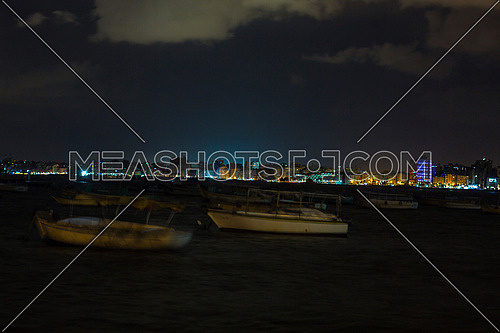 shot for sea shore showing fishing boats at alexandria from day to night