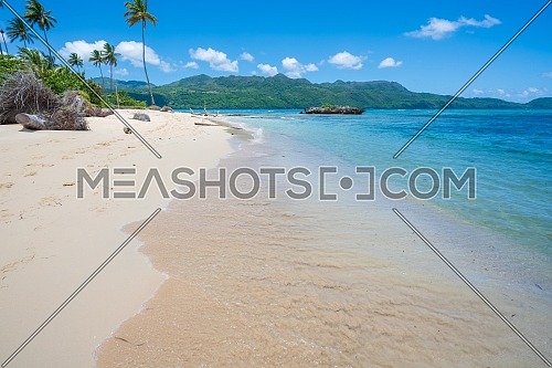 A view of exotic beach with sea, sand and blue sky,during the day on a public beach in Rincon Beach,Samana peninsula, Dominican Republic