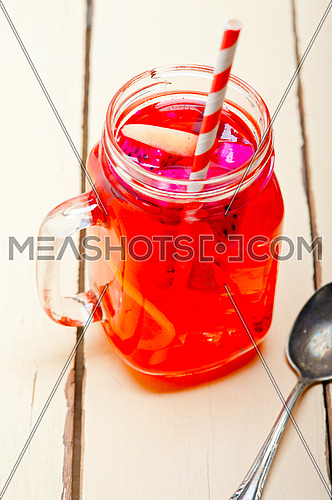 fresh fruit punch refreshing summer  drink over white rustic wood table