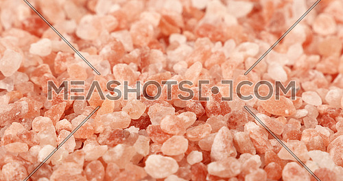 Close up background texture of large crystals pink Himalayan salt, high angle view, selective focus