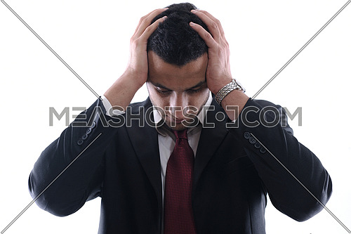 Portrait of a young business man looking depressed from work isolated over white background in studio