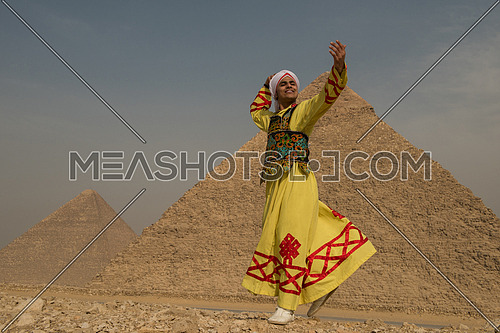 traditional Egyptian sufi dancer performing at Giza pyramids with