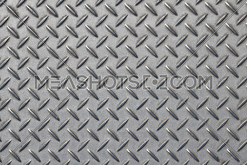 Gray industrial anti slip embossed metal steel plate with diagonal bumps of diamond pattern texture, background, close up