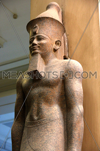 a photo from inside the Egyptian museum showing a display of monumental statue belonging to the pharaohs civilization