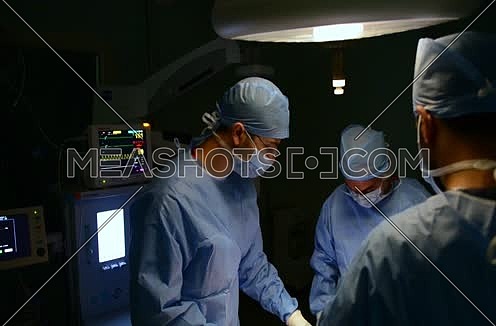 doctors performing procedure in operating room