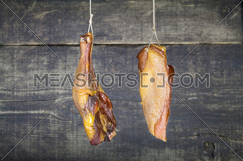 Smoked Chicken Meat Hanging on the Rope Against Wooden Background