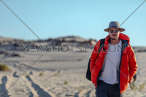 Male tourist walking on sands while exploring Sinai Trail from Ain Hodouda at day.