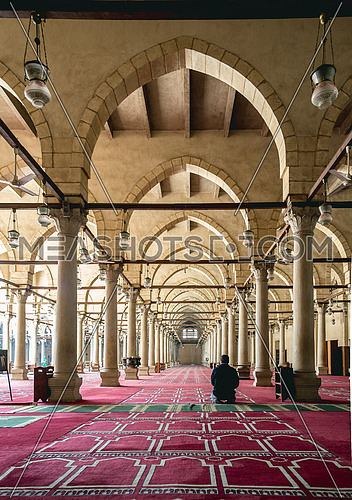 interior praying area in Amru ibn Elaas mosque in cairo Egypt with one man praying from behind