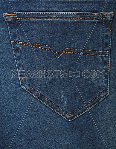 Dark indigo blue washed cotton jeans denim texture background with back pocket, close up