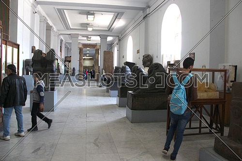 a photo from inside the Egyptian museum showing some monumental statues and visitors -- editorial value comes from tourism news