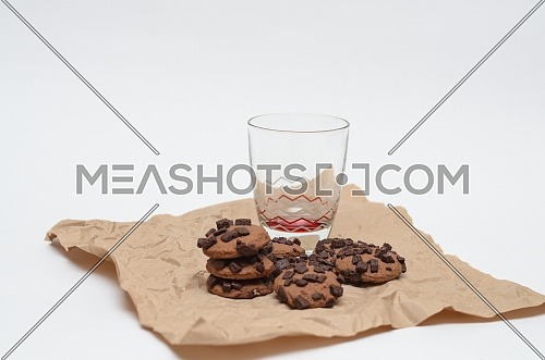An empty glass and chocolate chips cookies