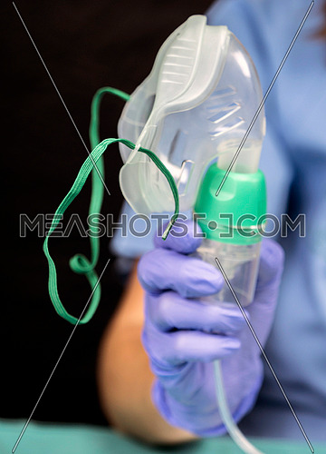 Nurse prepares oxygen mask in hospital, conceptual image