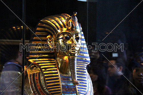 a photo from inside the Egyptian museum showing the  face and statue of king TUTANKHAMEN ancient Egyptian pharaoh