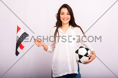A beautiful young woman encourages the Egyptian football team, holding the flag of Egypt