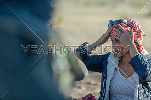 Close up for female tourist wearing bedouin traditions headscarf at Ain hodouda in Sinai at day