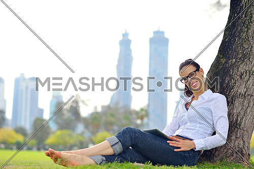 Beautiful young student  woman study with tablet in park
