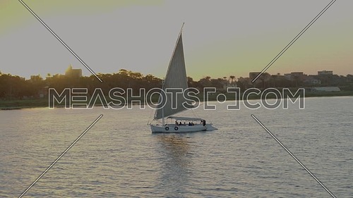 Fly over the River Nile showing a Sailboat at sunset.