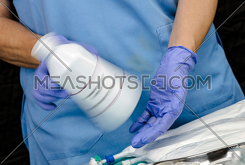 Nurse shaking enteral Nutrition bottle in a hospital, Palliative Care, Conceptual Image