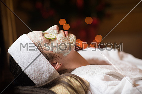 portrait of beautiful woman with cosmetic mask on face in spa and  wellness salon