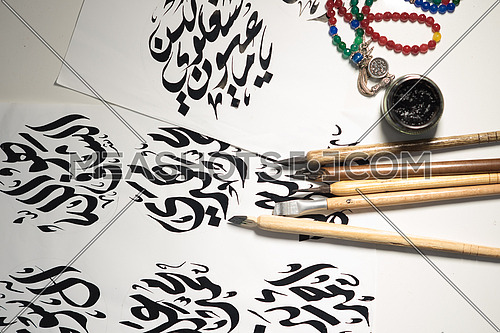 Arabic Calligraphy writing with Ink and Wooden Pen