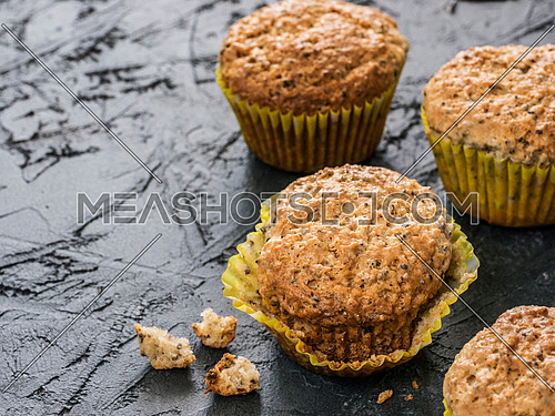 Muffins with chia seeds. Homemade muffin on black concrete textured background