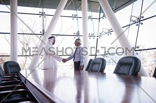 arabian businessman make deal and handshake with company director at modern meeting room
