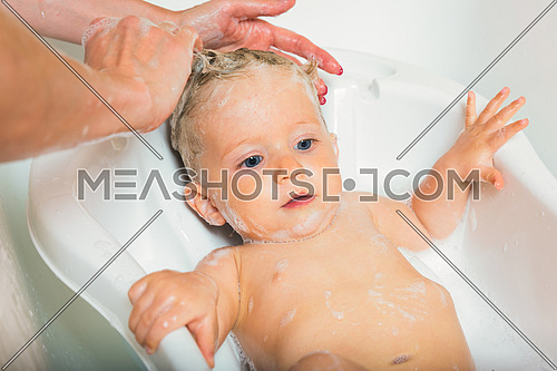 Pretty wet baby boy in the bath