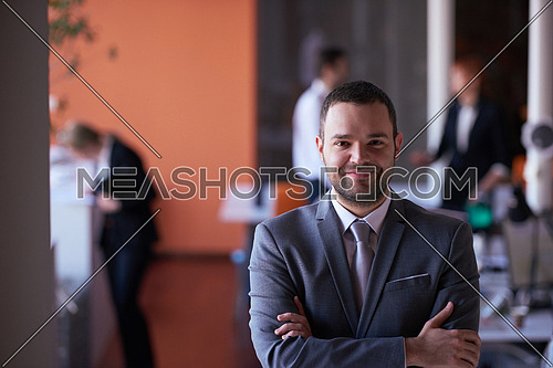 happy young business man portrait  at modern meeting office indoors