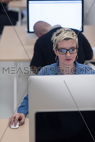 startup business, woman  working on dektop  computer at creative modern office relaxing and have fun