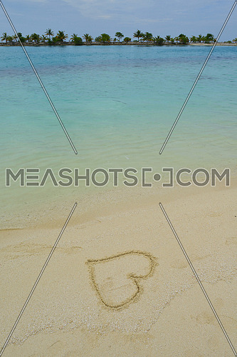 tropical beach nature landscape scene with white sand at summer with a heart shape on the sand