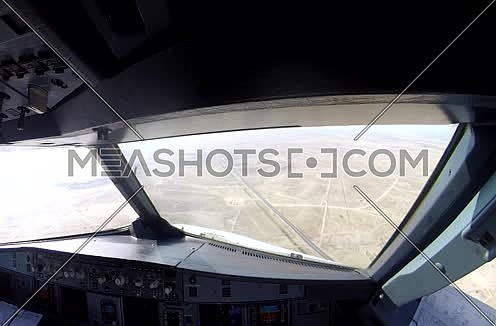 inside cockpit shot  flying over the desert at day