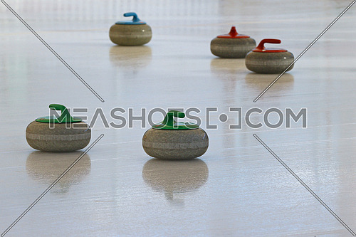 Curling stones standing still on the ice during a game